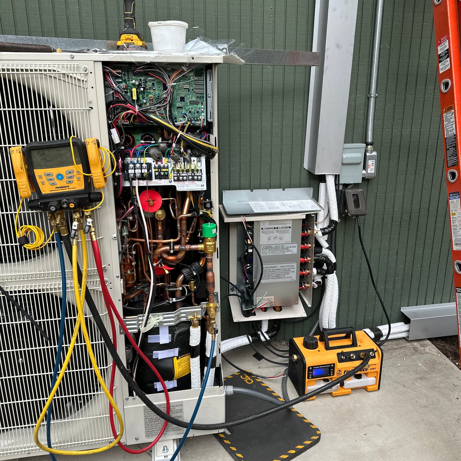 Air Dynamics of Tulsa HVAC Technician performing repair work.